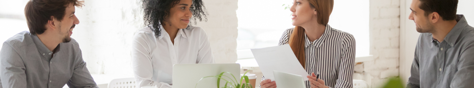 multiracial-male-and-female-colleagues-having-discussion-at-team-meeting