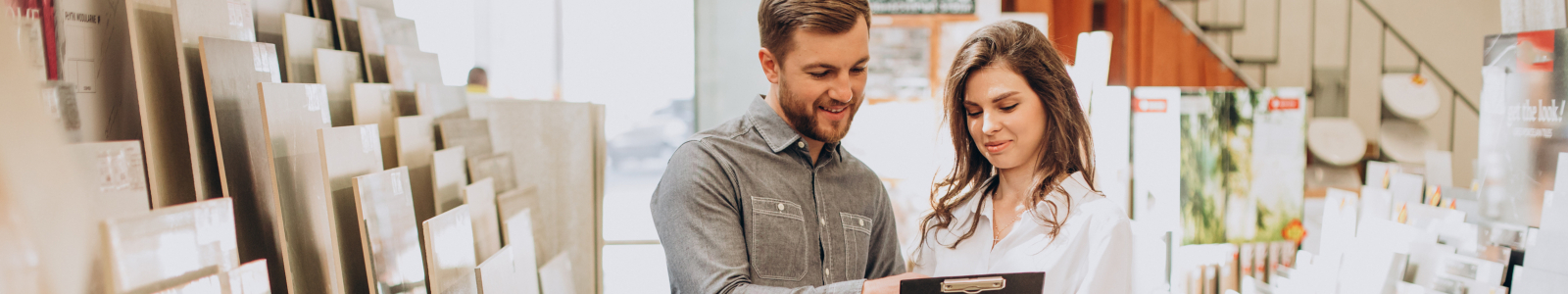 young-couple-choosing-tiles-at-building-market young-couple-choosing-tiles-at-building-market